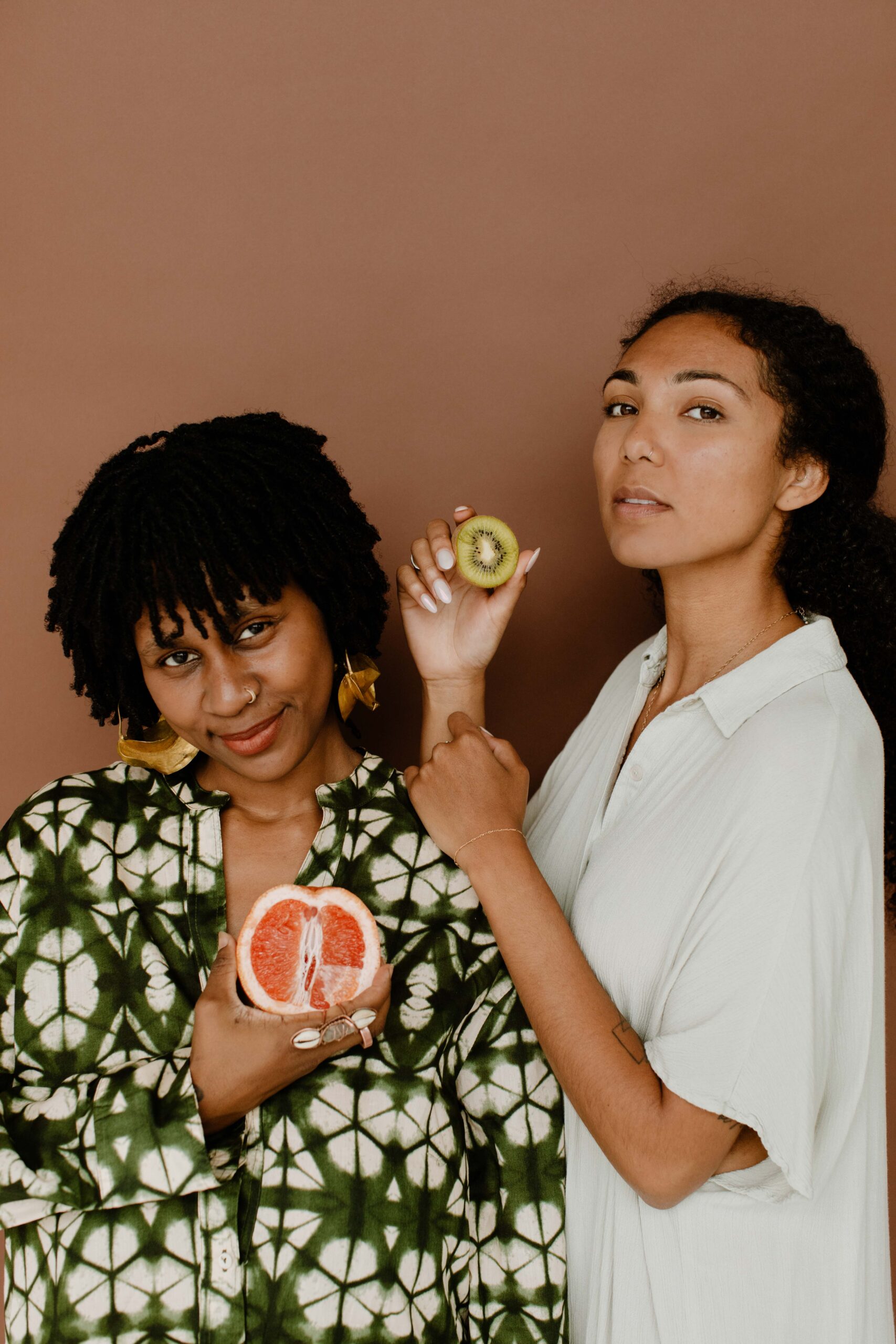 Anuuma and friend holding fruit to represent the sacred womb.